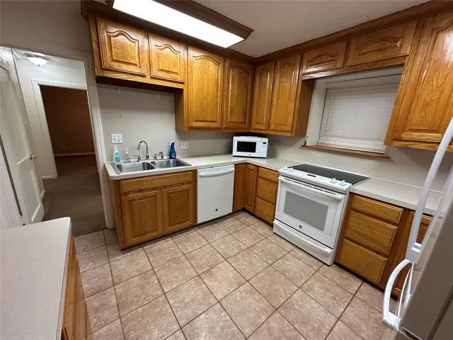 a kitchen with a sink appliances and cabinets
