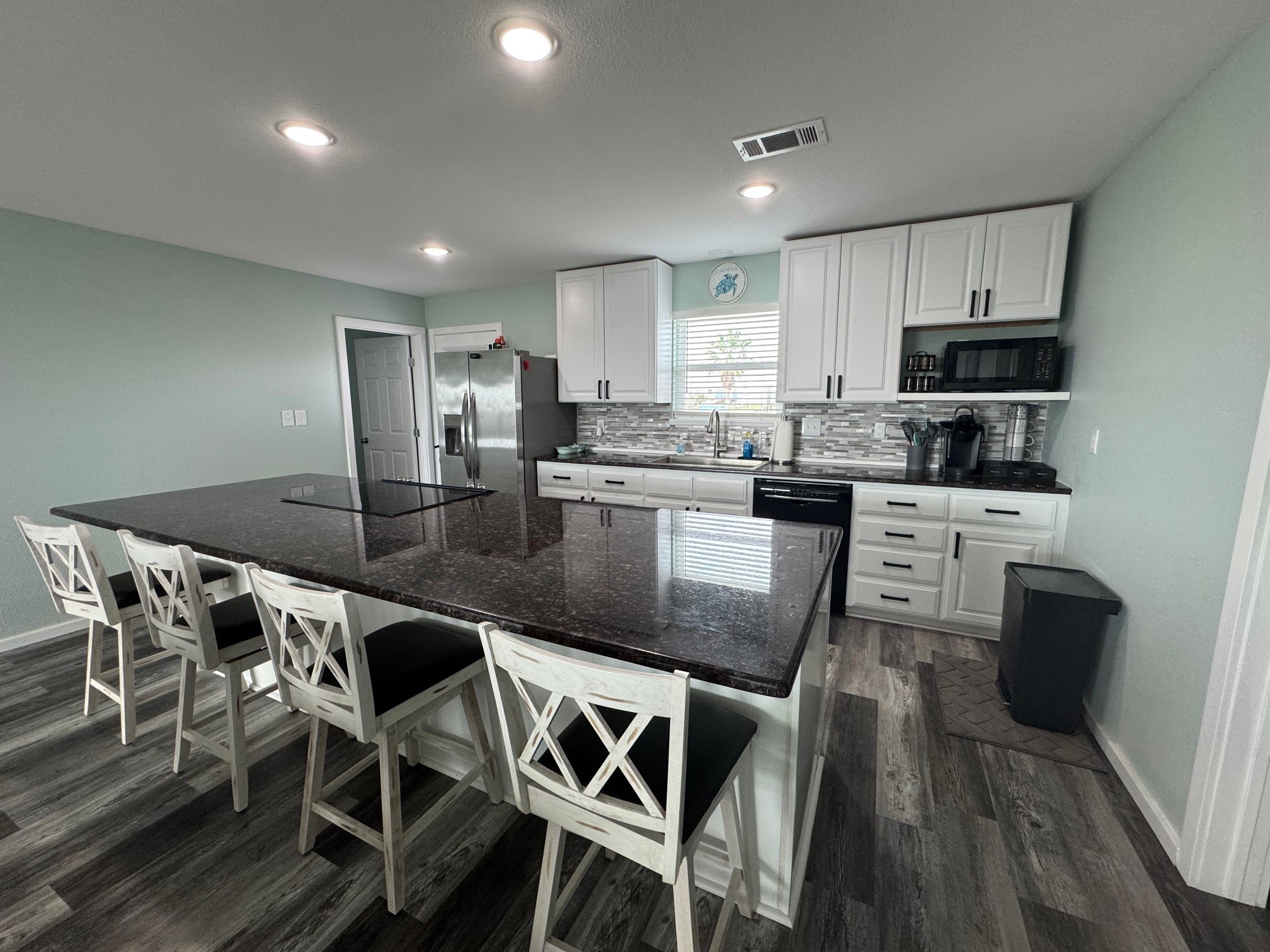 1118 County Road 204 Sargent, TX 77414 - Photo 11 of 36 a kitchen with stainless steel appliances granite countertop a stove a sink a microwave a refrigerator and cabinets
