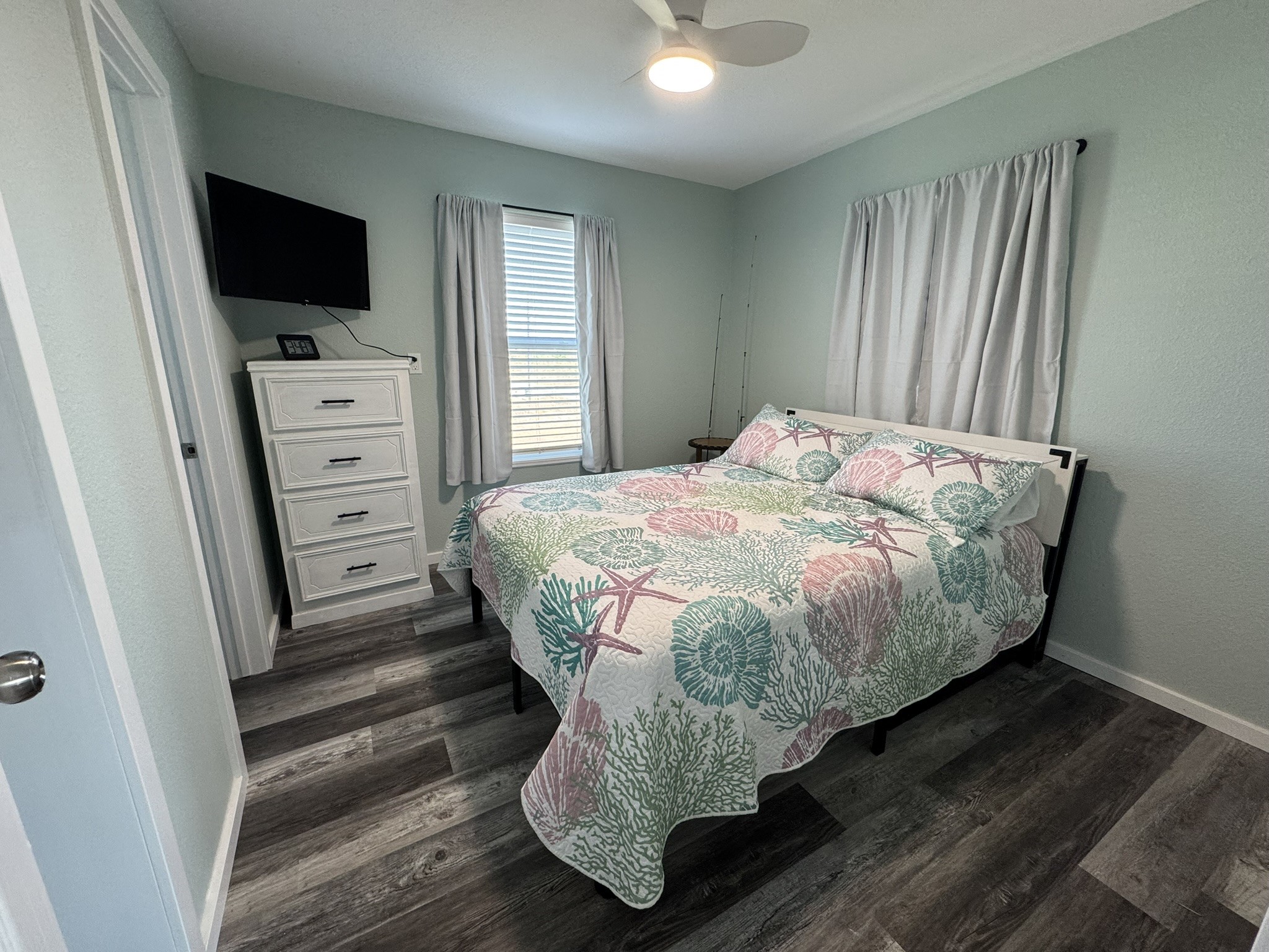 1118 County Road 204 Sargent, TX 77414 - Photo 18 of 36 a bedroom with a bed and flat screen tv