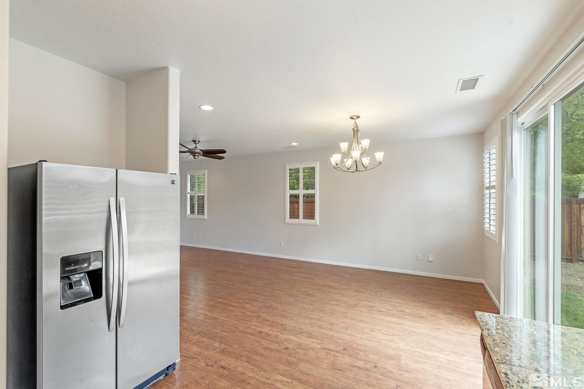 310 Pesaro Way Reno, NV 89521 - Photo 13 of 25 a view of a refrigerator in kitchen and wooden floor