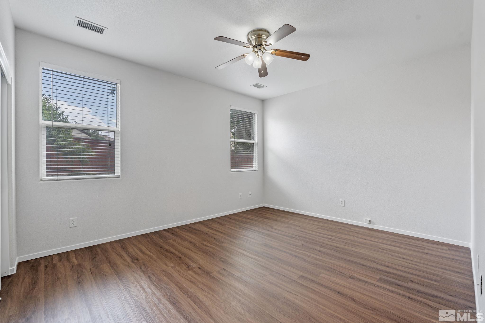 310 Pesaro Way Reno, NV 89521 - Photo 14 of 25 a view of empty room with wooden floor and fan