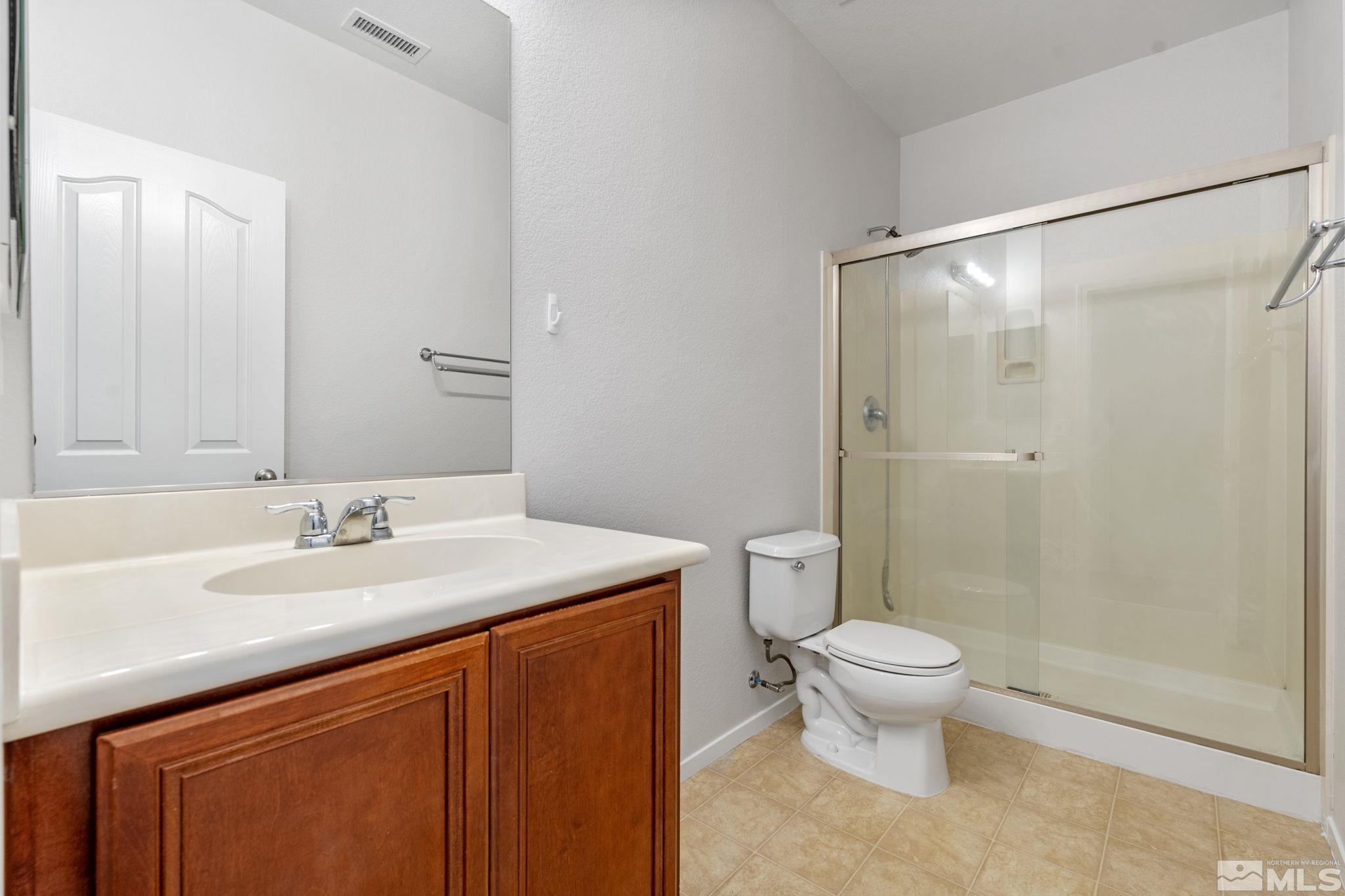 310 Pesaro Way Reno, NV 89521 - Photo 16 of 25 a bathroom with a granite countertop sink toilet and shower