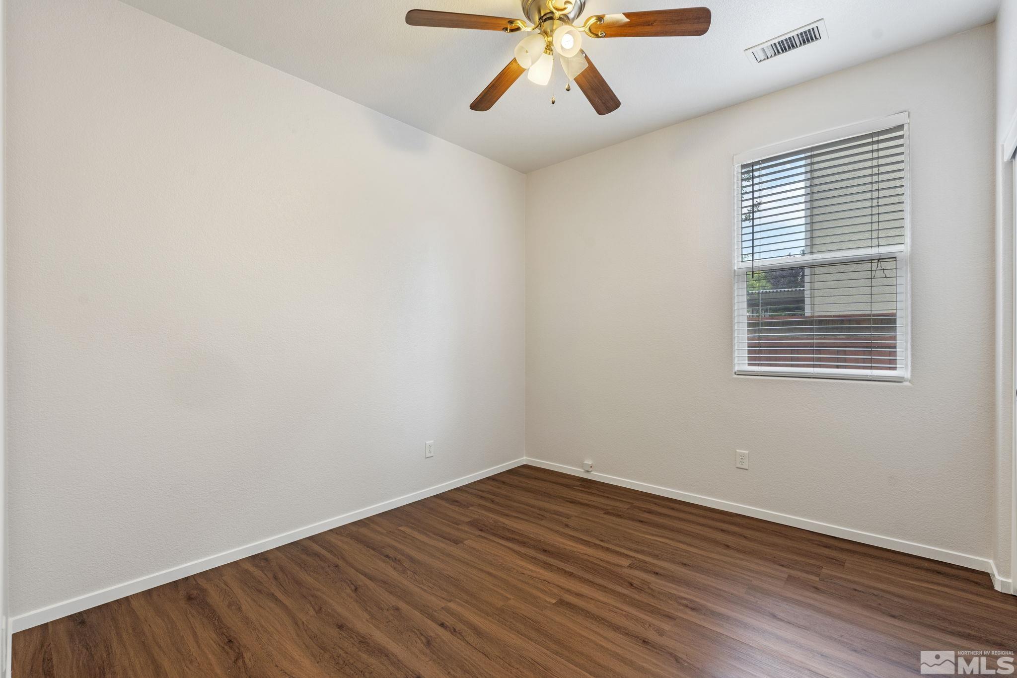 310 Pesaro Way Reno, NV 89521 - Photo 17 of 25 wooden floor in an empty room with a window