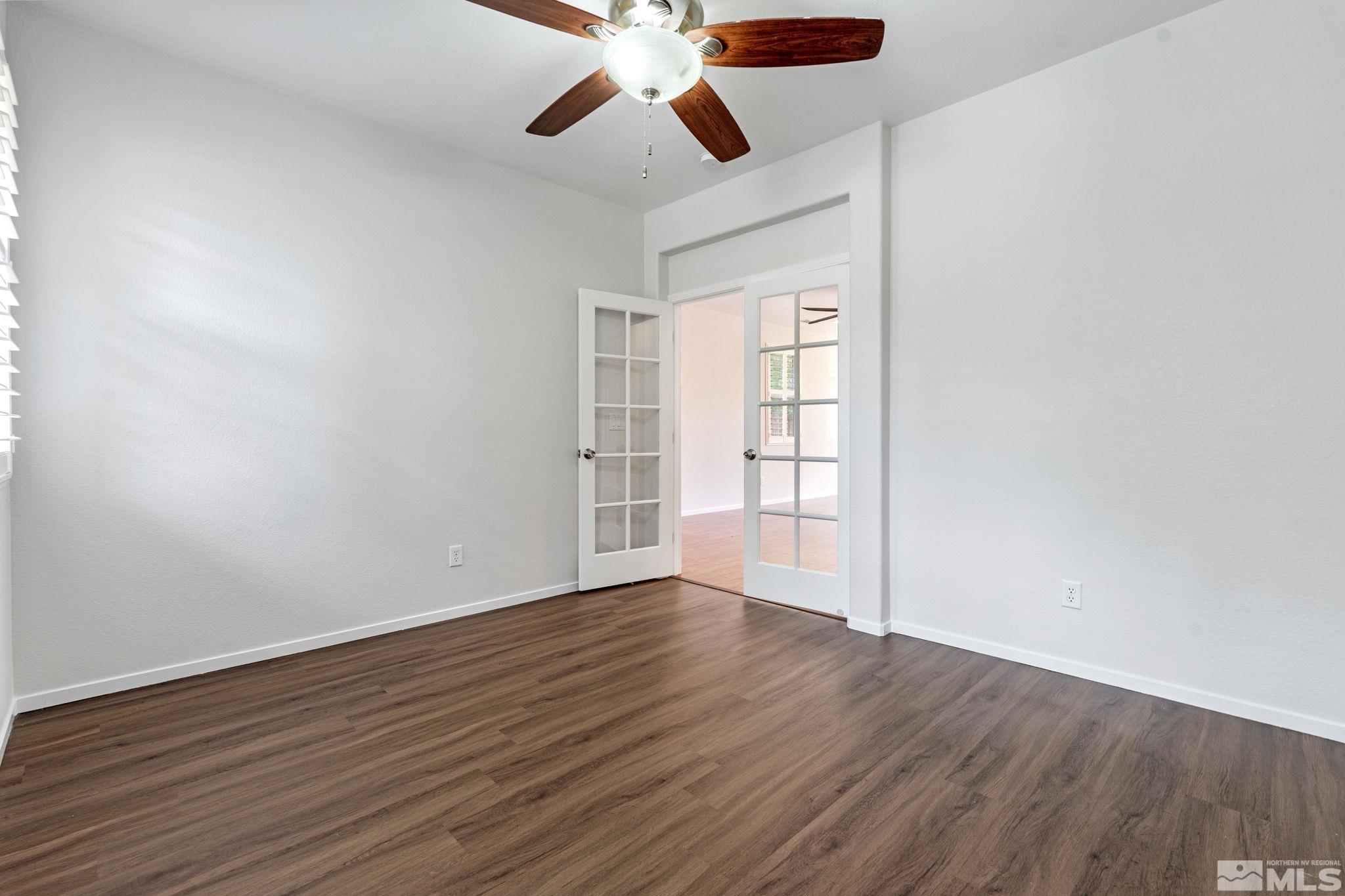 310 Pesaro Way Reno, NV 89521 - Photo 20 of 25 a view of an empty room with wooden floor and a ceiling fan