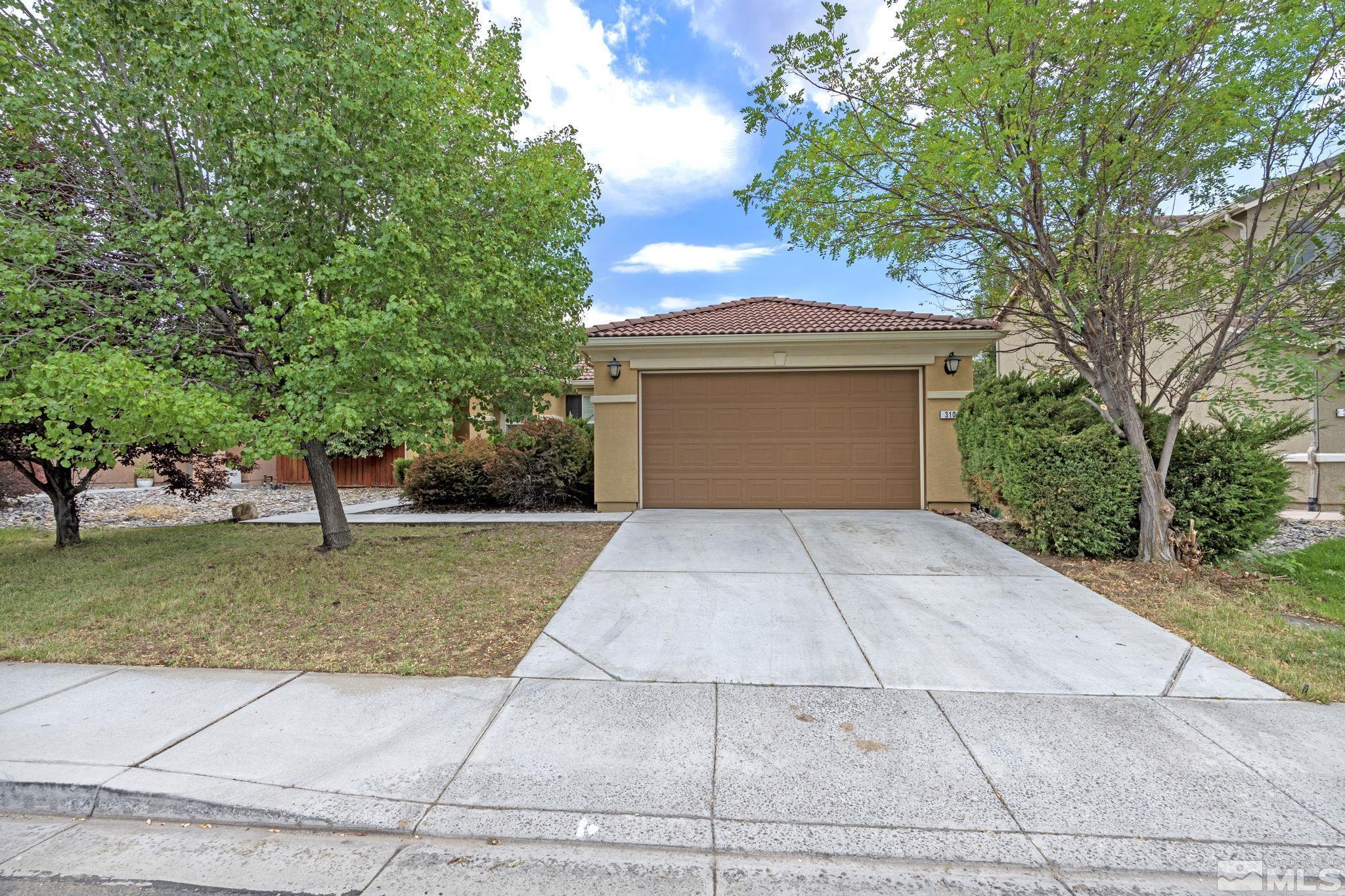 310 Pesaro Way Reno, NV 89521 - Photo 2 of 25 a front view of a house with a yard and trees