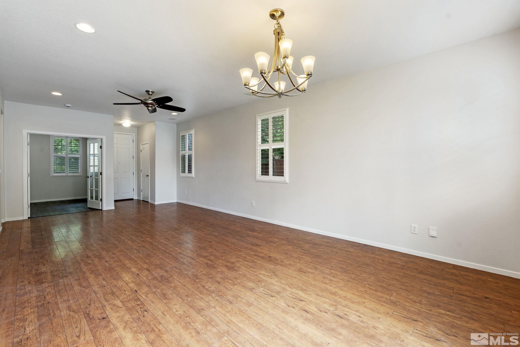 310 Pesaro Way Reno, NV 89521 - Photo 5 of 25 a view of an empty room with wooden floor and chandelier