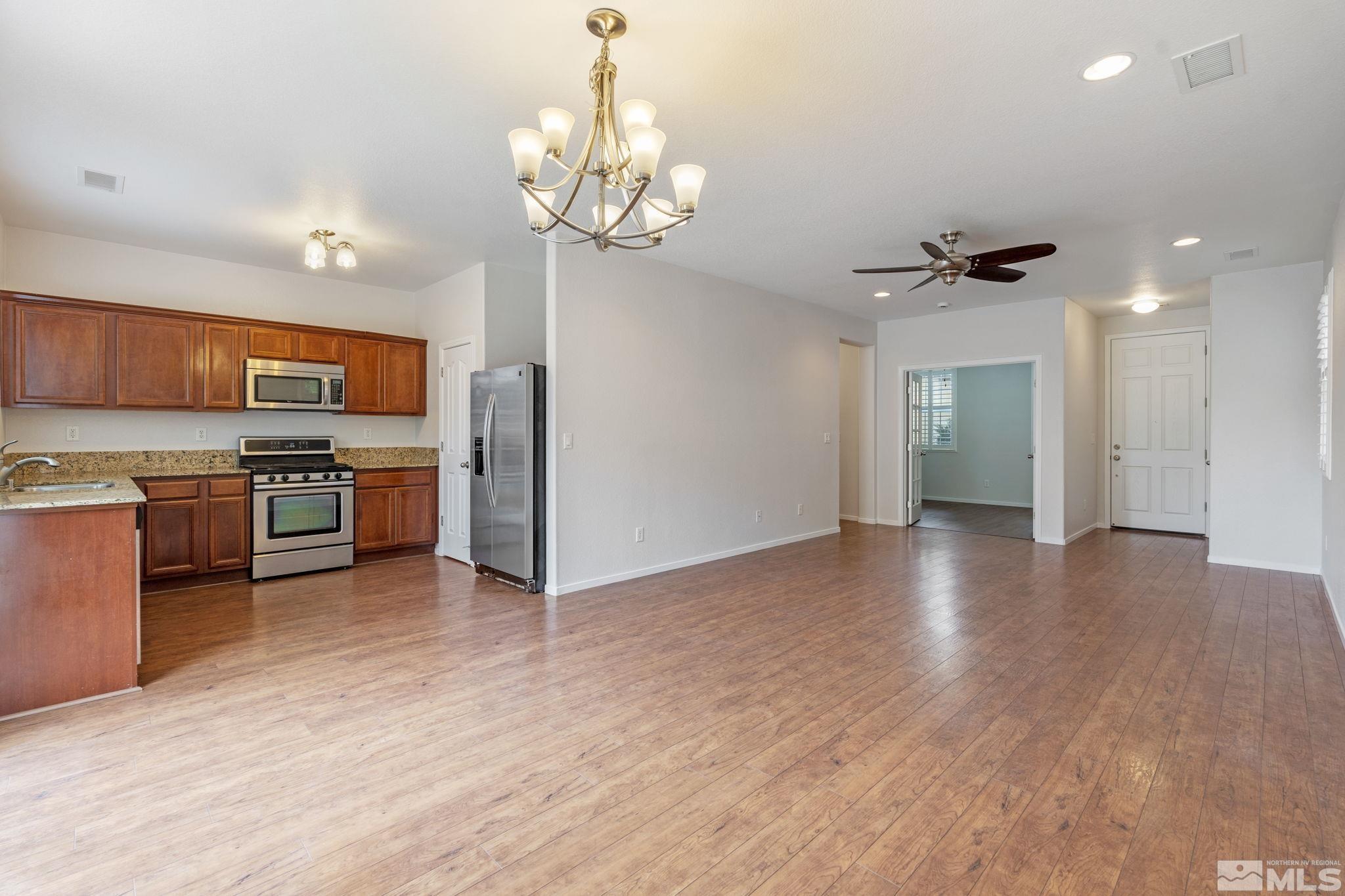 310 Pesaro Way Reno, NV 89521 - Photo 6 of 25 a view of kitchen with sink microwave and stove
