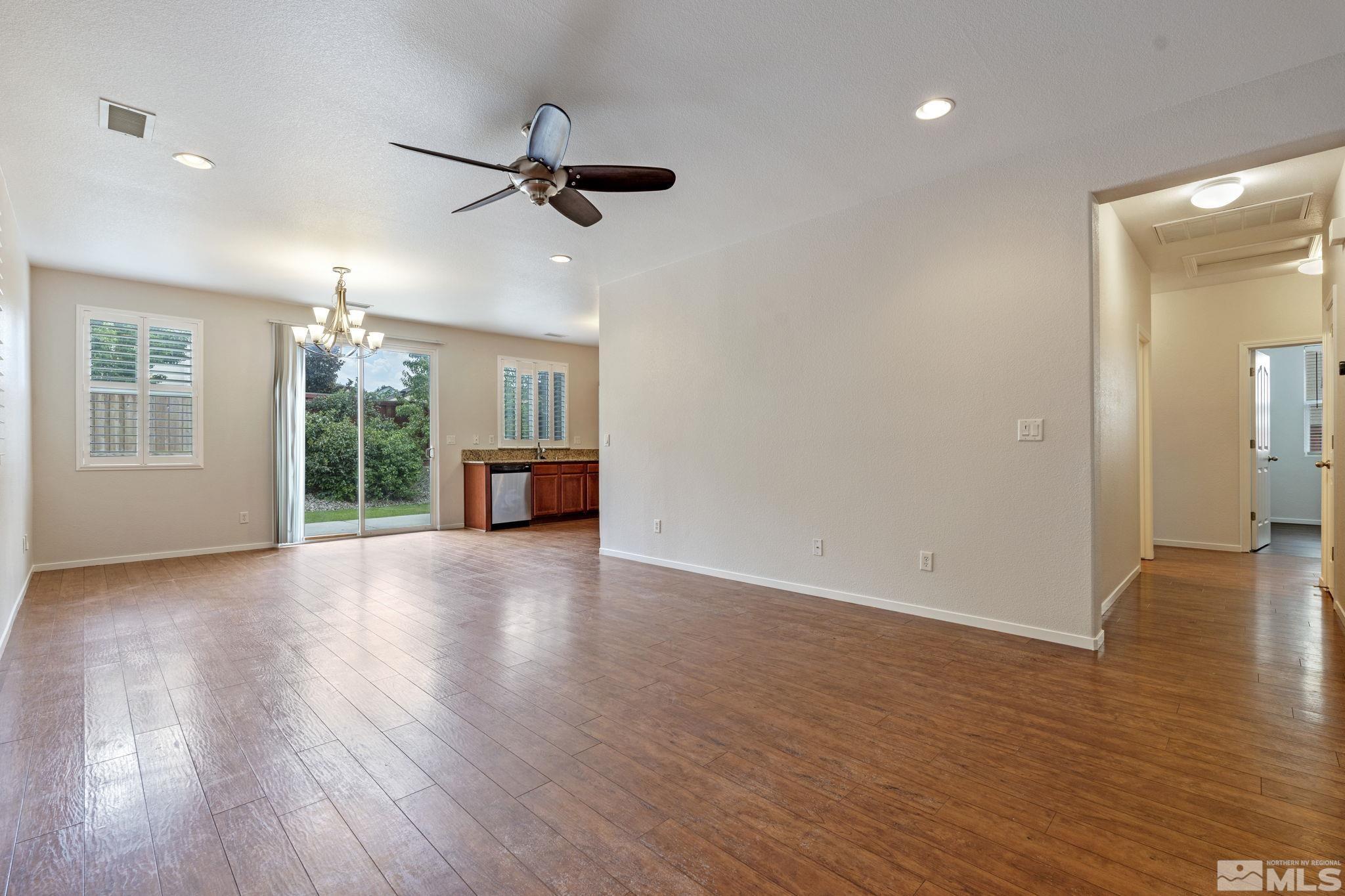 310 Pesaro Way Reno, NV 89521 - Photo 7 of 25 a view of a livingroom with hardwood floor a ceiling fan and windows