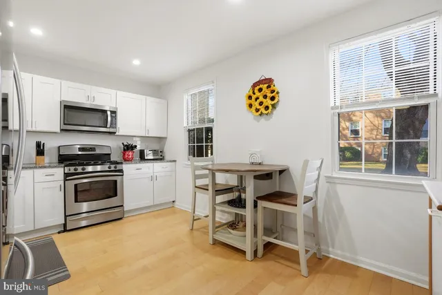 a kitchen with a sink cabinets and window