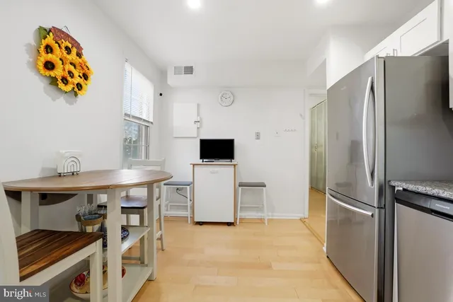 a kitchen with stainless steel appliances granite countertop a refrigerator and a stove