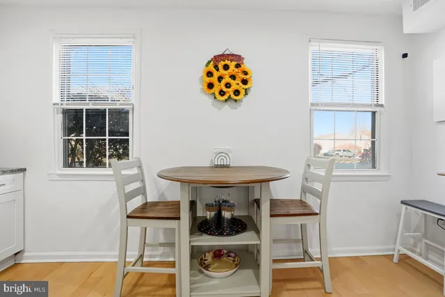 a table and chair in a room with a window