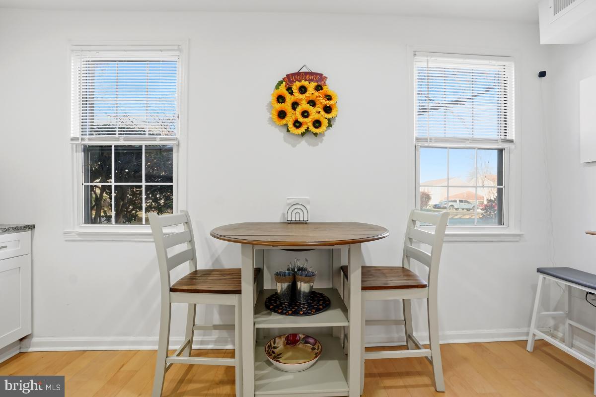 794 Quince Orchard Boulevard, Unit T2 Gaithersburg, MD 20878 - Photo 20 of 30 a table and chair in a room with a window