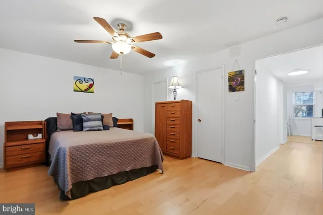 a bedroom with bed and a ceiling fan