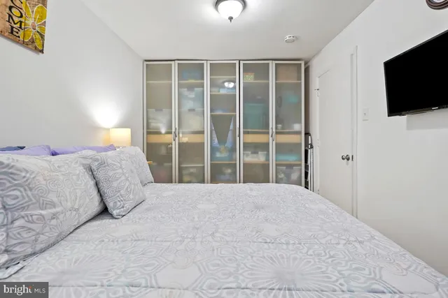 a large bedroom with a bed and tv