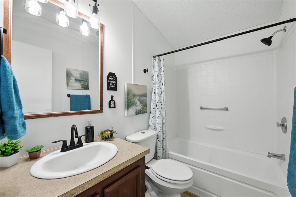 197 Pondview Drive Decatur, TX 76234 - Photo 17 of 28 a bathroom with a sink a toilet and shower