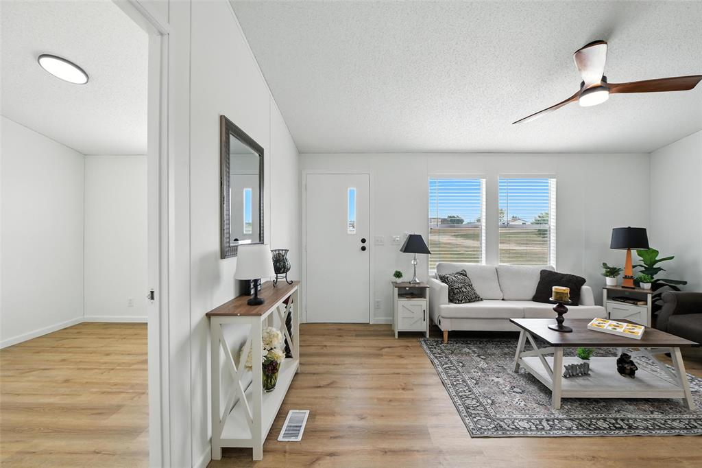 197 Pondview Drive Decatur, TX 76234 - Photo 6 of 28 a living room with furniture and a table