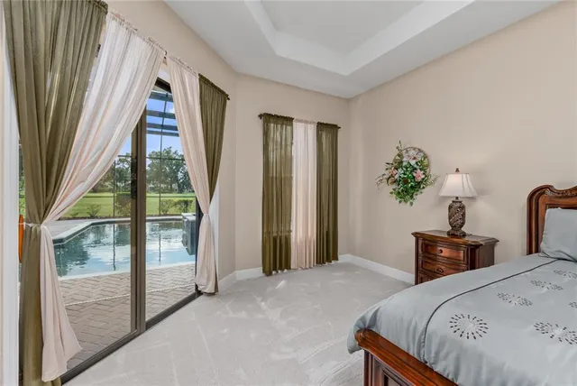 a bedroom with a bed and a flat tv screen on dresser