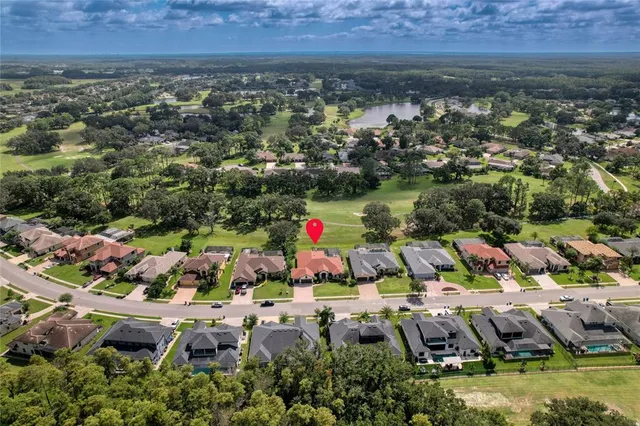 an aerial view of residential houses with outdoor space and swimming pool