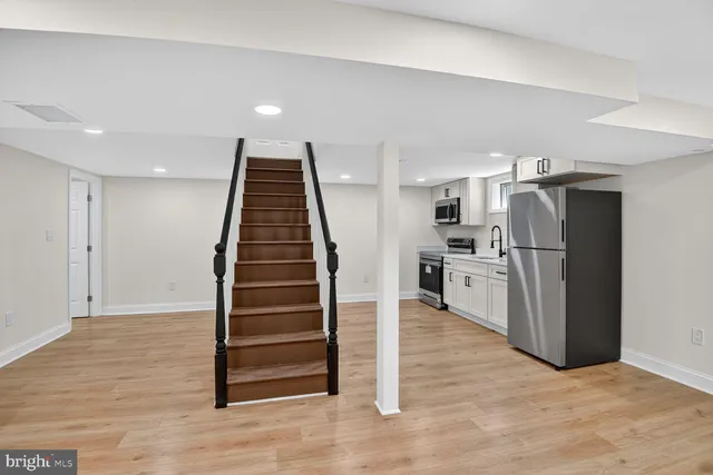 a view of kitchen with refrigerator and microwave