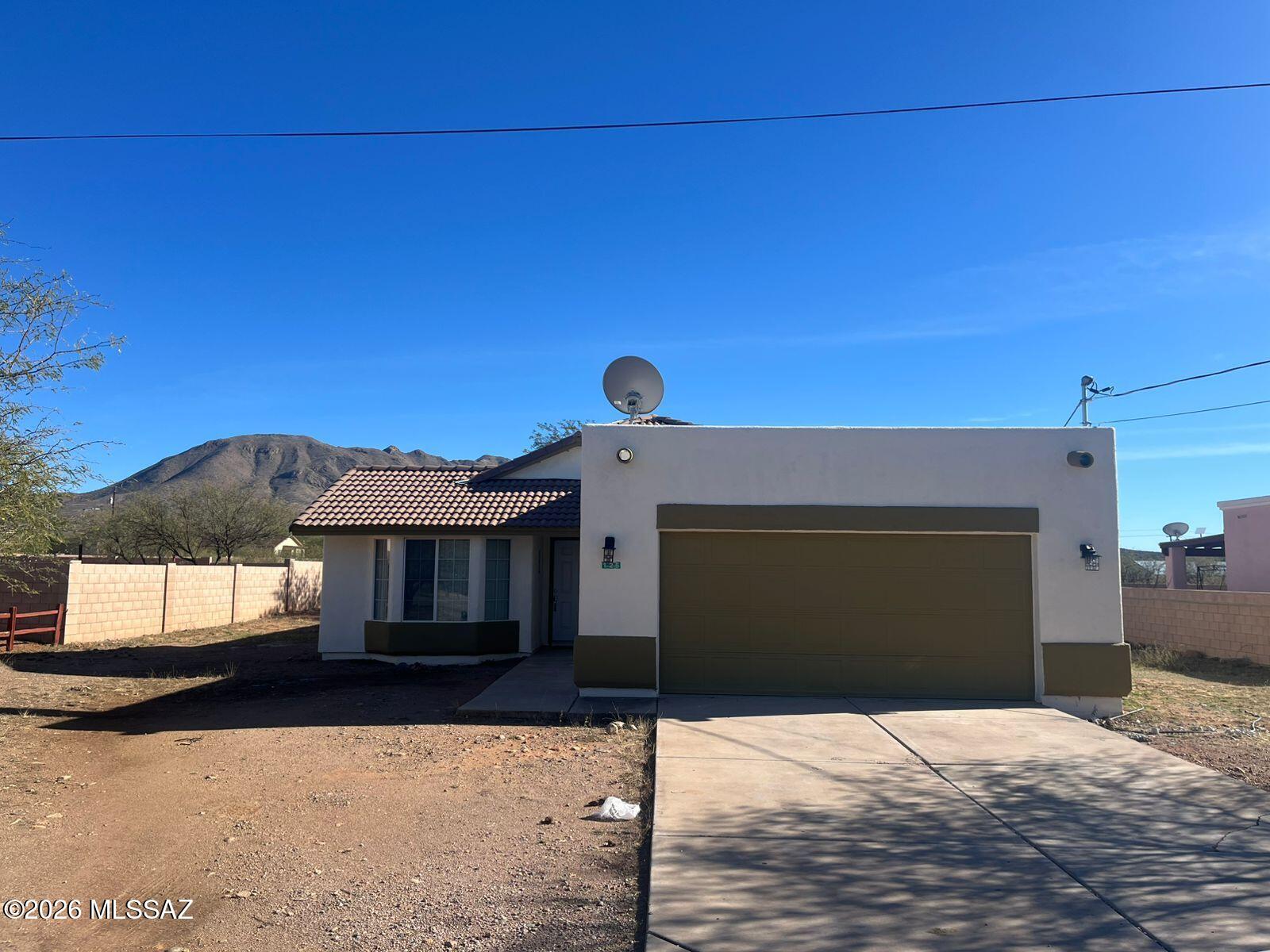 125 Alemania Court Rio Rico, AZ 85648 - Photo 1 of 1 a front view of a house with a yard