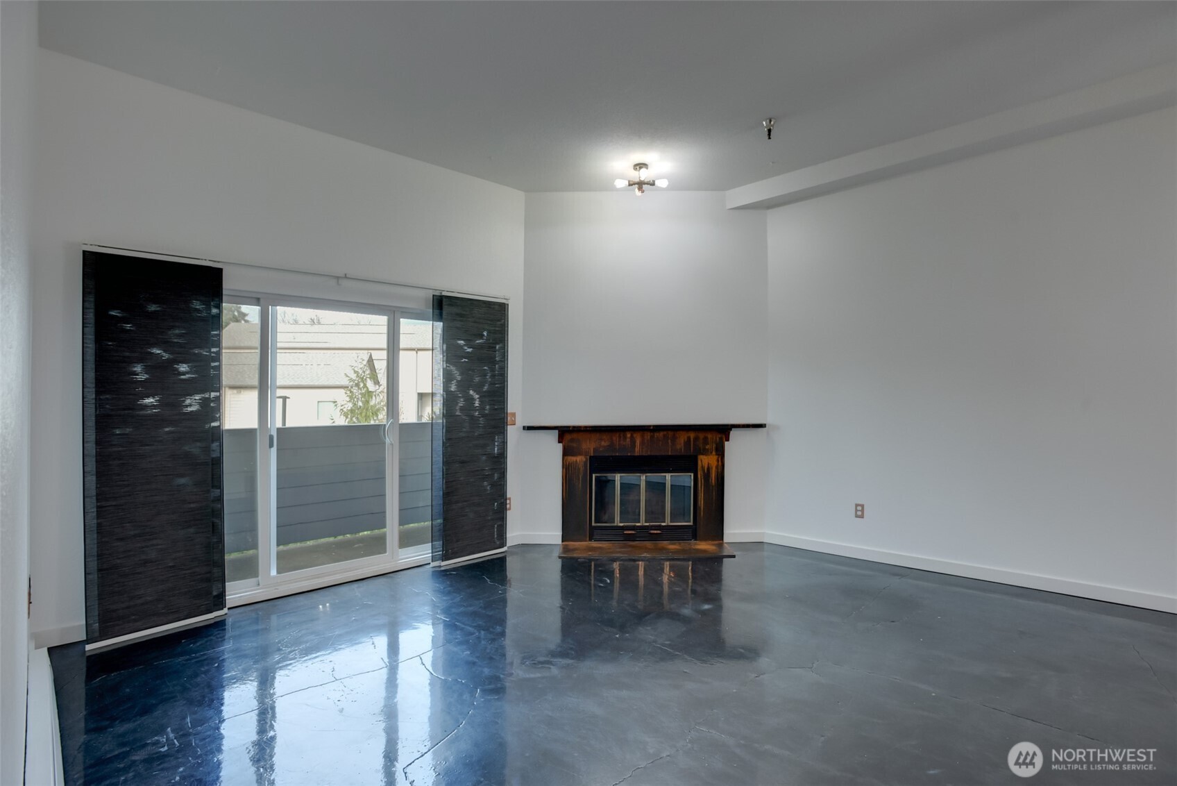 1100 Harrington Avenue Northeast, Unit 310 Renton, WA 98056 - Photo 11 of 26 an empty room with wooden floor and windows
