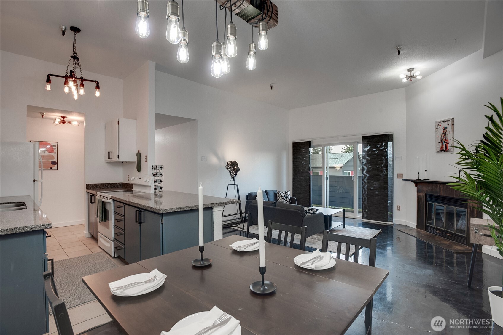 1100 Harrington Avenue Northeast, Unit 310 Renton, WA 98056 - Photo 11 of 40 a open dining room with furniture a chandelier and wooden floor
