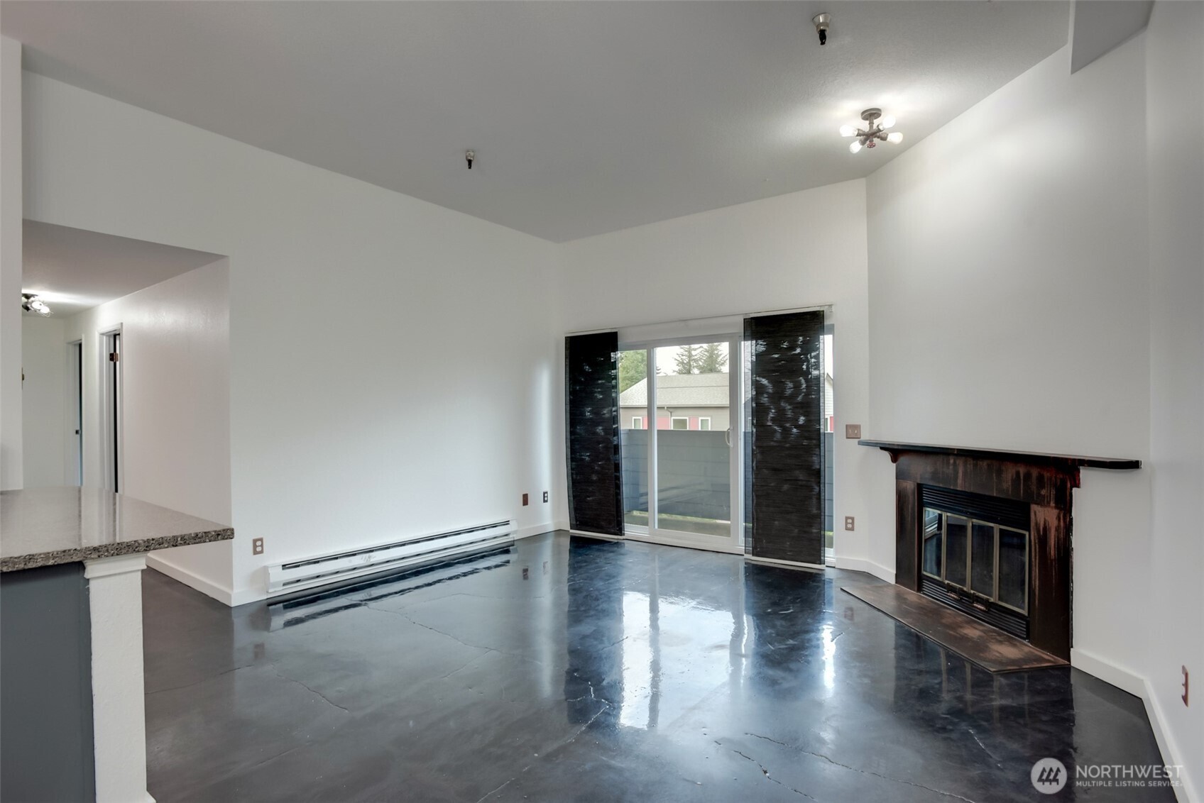 1100 Harrington Avenue Northeast, Unit 310 Renton, WA 98056 - Photo 12 of 26 an empty room with wooden floor and windows