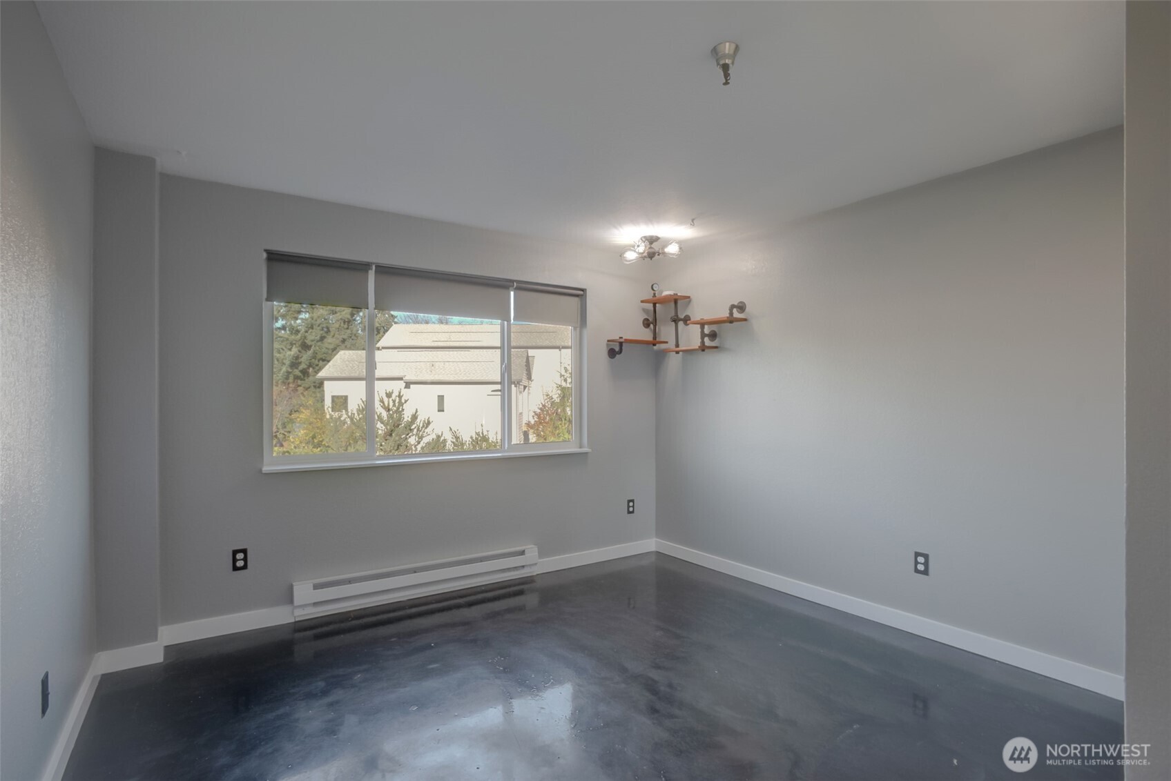 1100 Harrington Avenue Northeast, Unit 310 Renton, WA 98056 - Photo 14 of 26 an empty room with wooden floor and windows