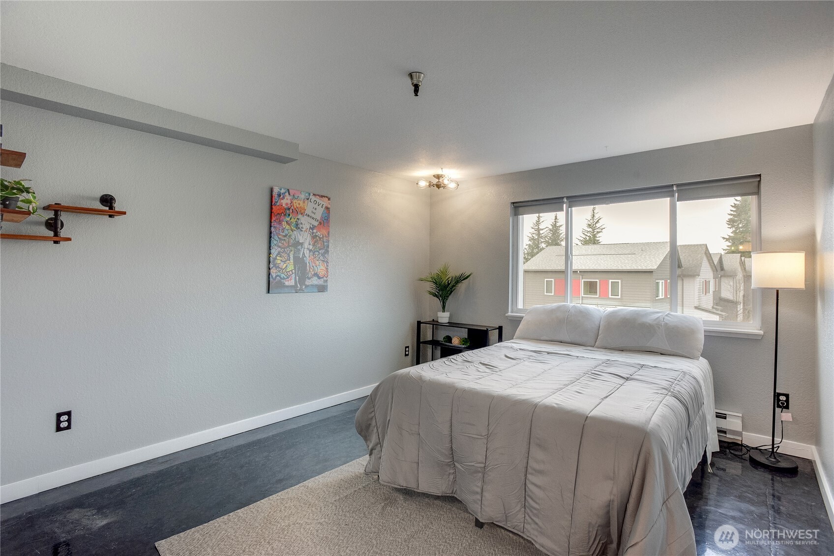 1100 Harrington Avenue Northeast, Unit 310 Renton, WA 98056 - Photo 21 of 40 a bedroom with a large bed and a large window
