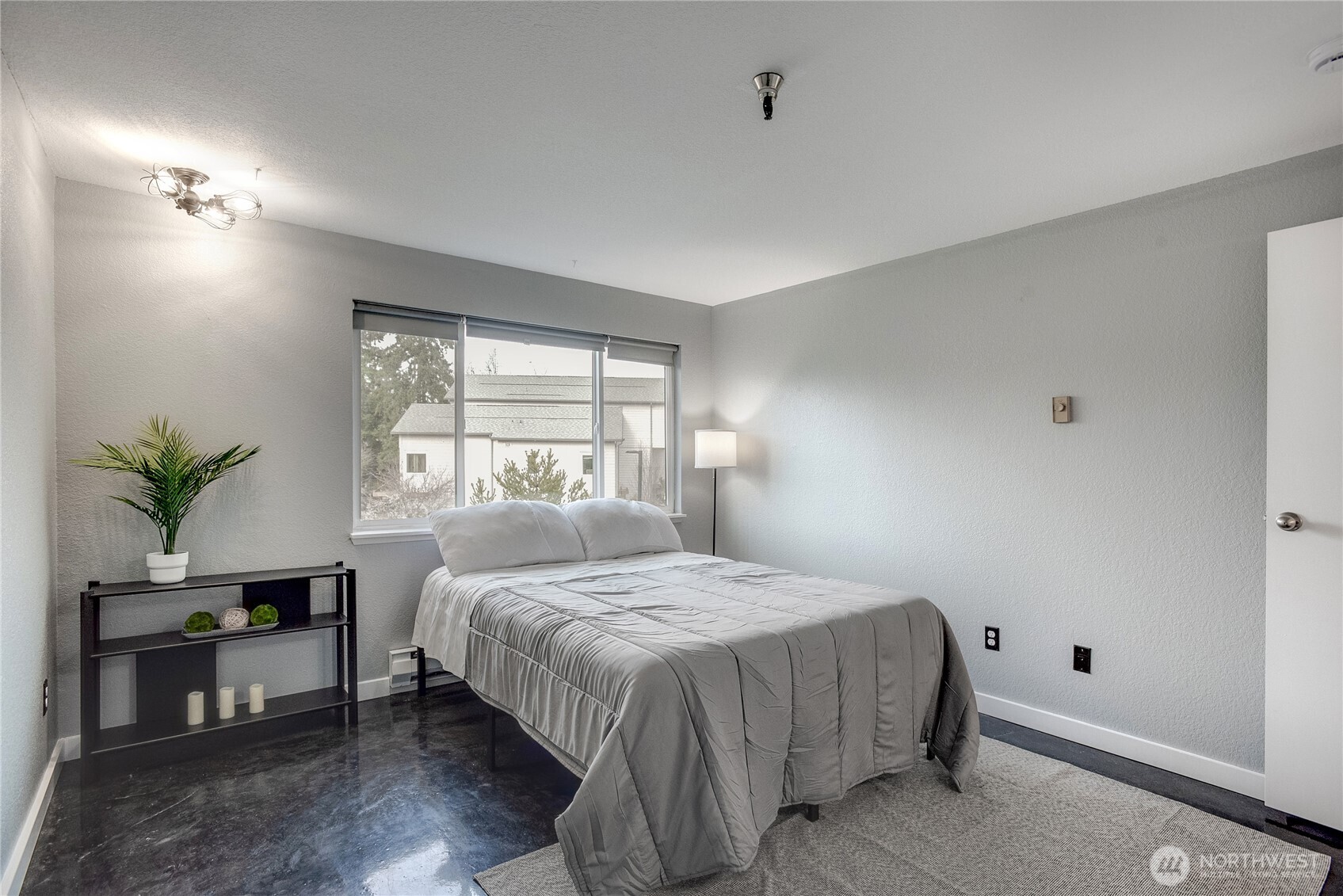 1100 Harrington Avenue Northeast, Unit 310 Renton, WA 98056 - Photo 22 of 40 a bedroom with a bed table and a window