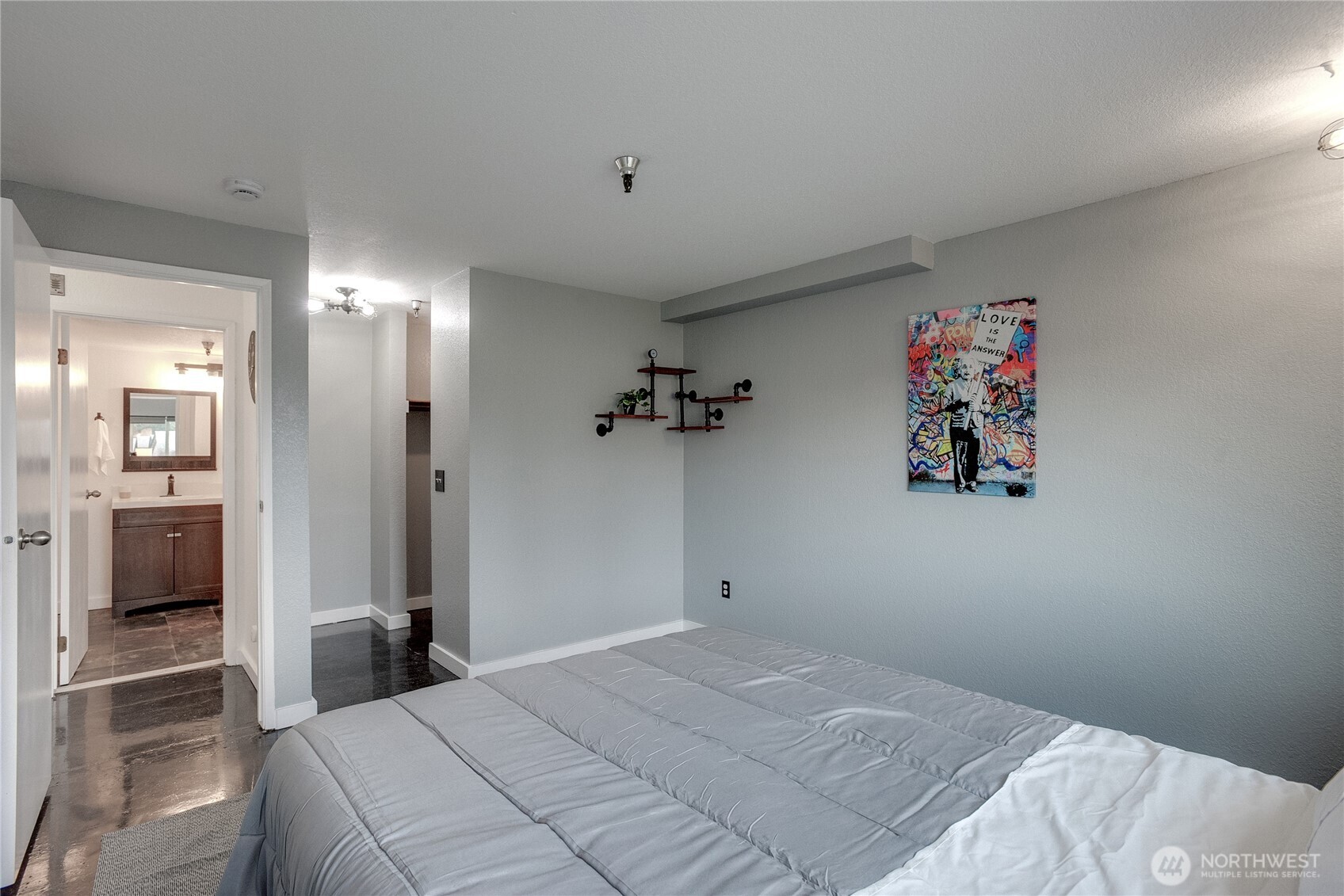 1100 Harrington Avenue Northeast, Unit 310 Renton, WA 98056 - Photo 23 of 40 a bedroom with a bed and a chandelier