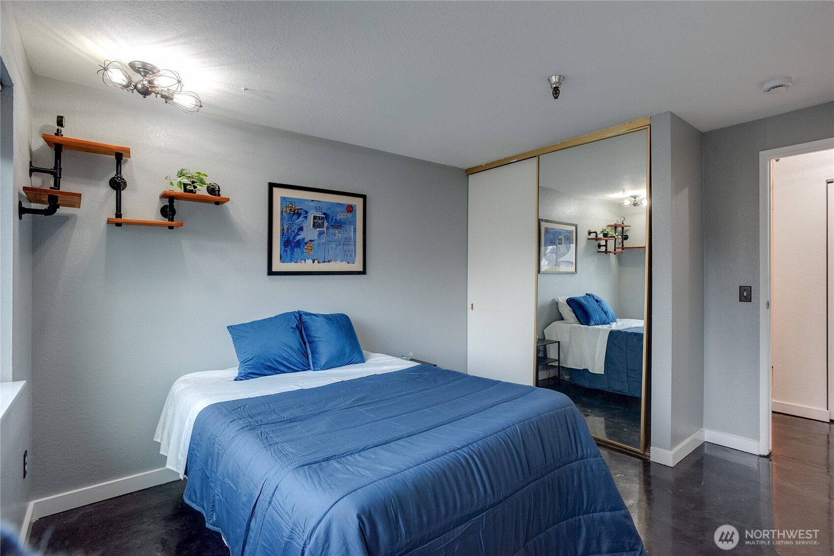 1100 Harrington Avenue Northeast, Unit 310 Renton, WA 98056 - Photo 25 of 40 a bedroom with a bed and wooden floor