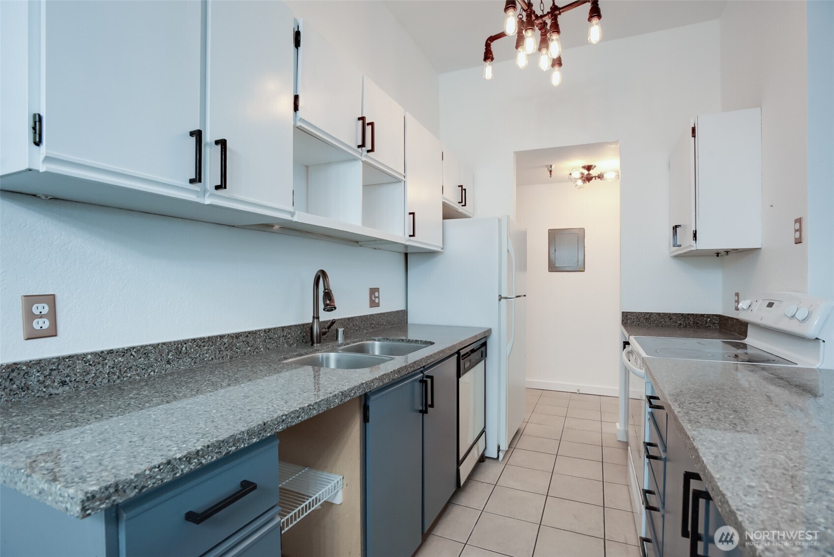1100 Harrington Avenue Northeast, Unit 310 Renton, WA 98056 - Photo 4 of 26 a kitchen with stainless steel appliances granite countertop a sink a stove and a counter space