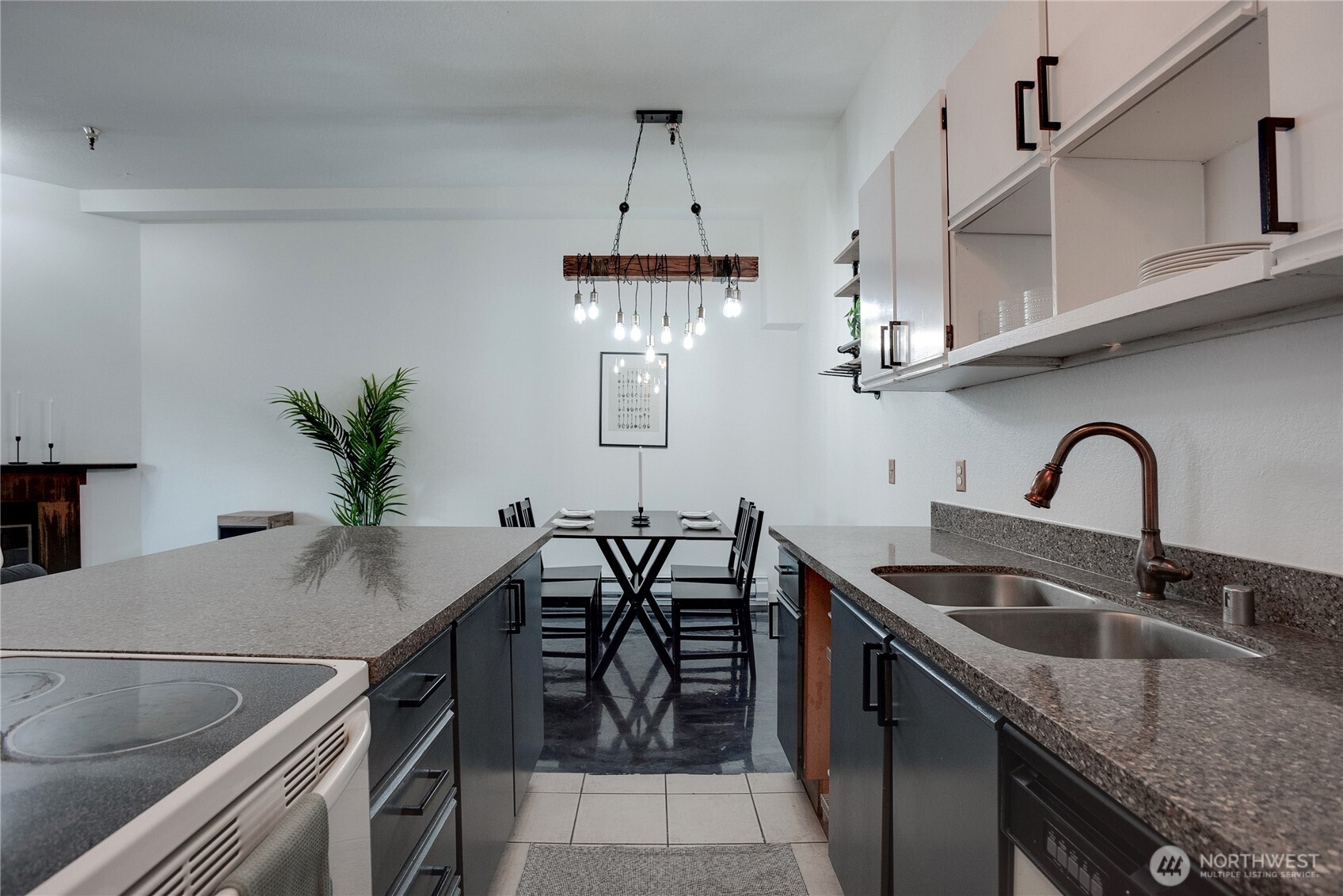 1100 Harrington Avenue Northeast, Unit 310 Renton, WA 98056 - Photo 4 of 40 a kitchen with stainless steel appliances granite countertop a sink a stove and a wooden floors