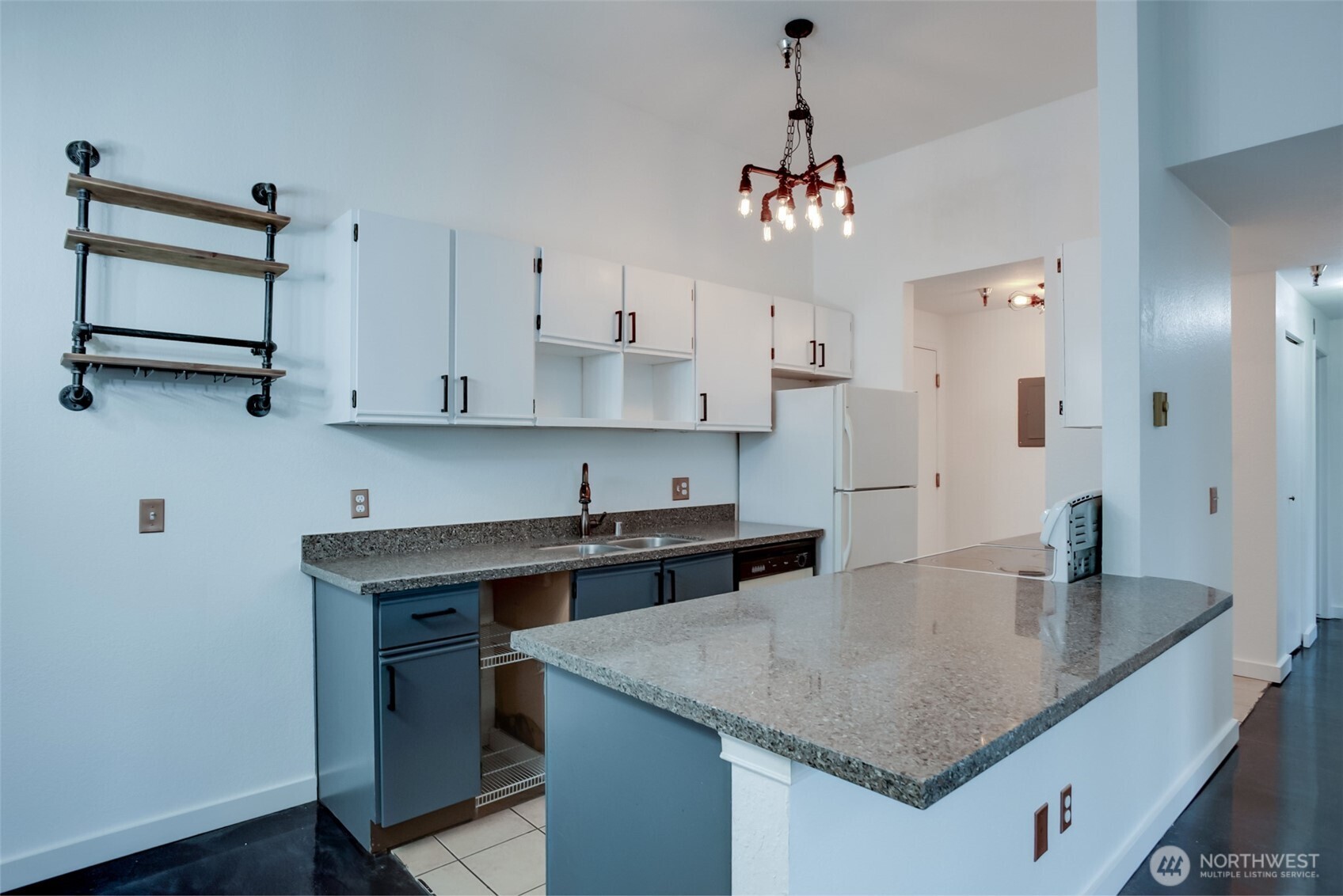 1100 Harrington Avenue Northeast, Unit 310 Renton, WA 98056 - Photo 7 of 26 a kitchen with stainless steel appliances granite countertop a sink a refrigerator and a stove top oven