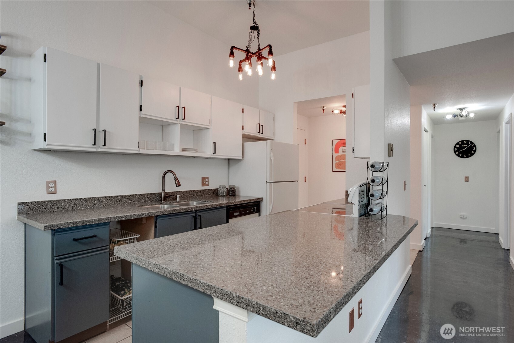 1100 Harrington Avenue Northeast, Unit 310 Renton, WA 98056 - Photo 9 of 40 a kitchen with kitchen island granite countertop a sink a center island stainless steel appliances and cabinets