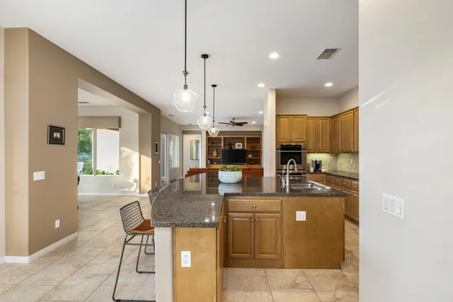 a kitchen with sink a counter top space and stainless steel appliances