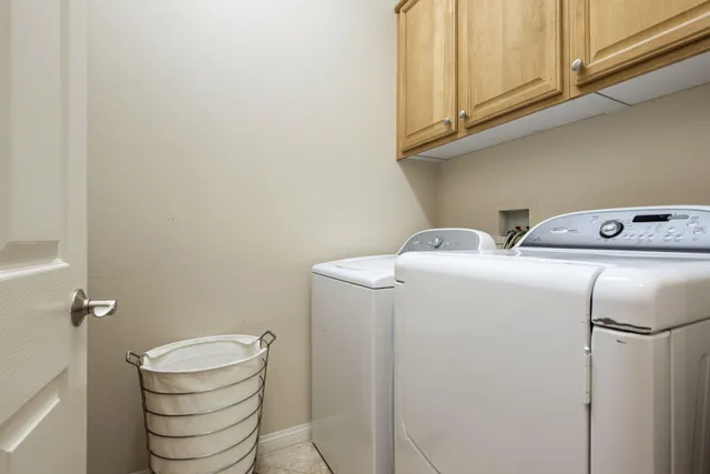 a view of a swimming pool with a patio and dining table