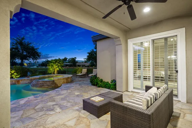 a view of a swimming pool with an outdoor space and seating area