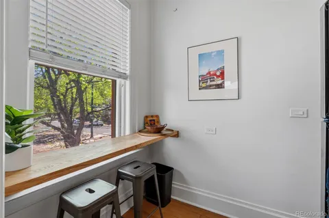a view of a workspace with furniture and window