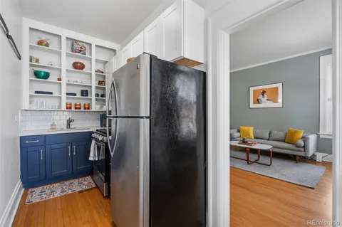 a kitchen with stainless steel appliances a refrigerator and a wooden cabinets