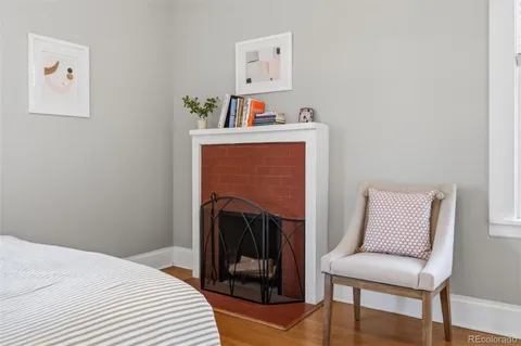 a bedroom with a bed and a chair