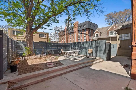 a view of a patio with iron fence
