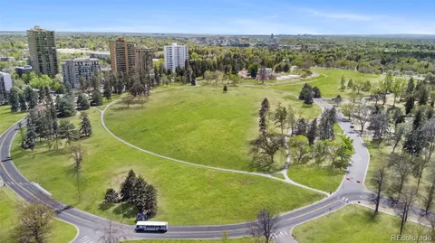 an aerial view of residential houses with outdoor space and swimming pool