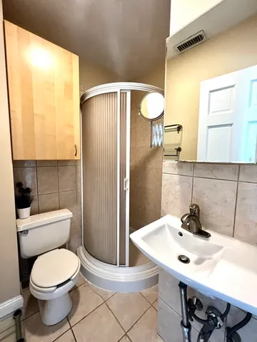 a bathroom with a sink a toilet and mirror