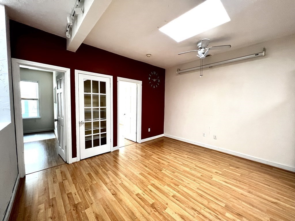 40-42 Winter Street, Unit 3 Boston, MA 02111 - Photo 3 of 12 wooden floor in an empty room with a window