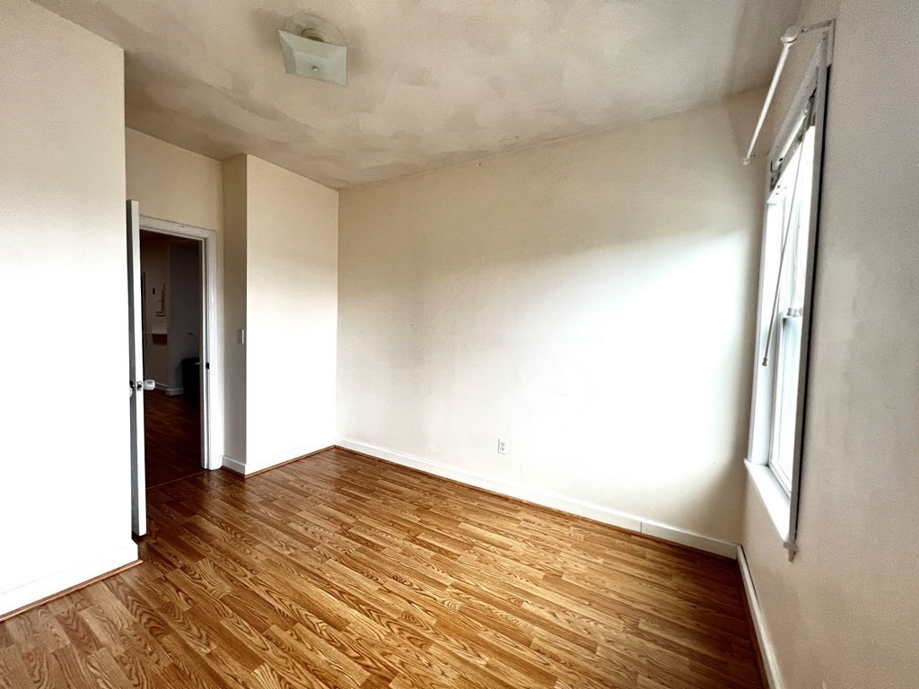 40-42 Winter Street, Unit 3 Boston, MA 02111 - Photo 5 of 12 a view of empty room with wooden floor