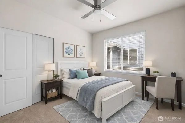 a bedroom with a bed a table and chair