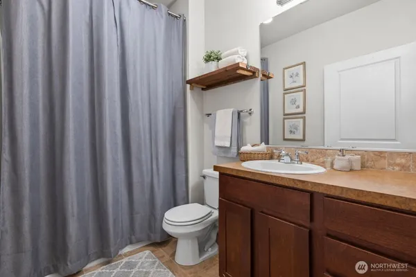a bathroom with a toilet a sink and mirror