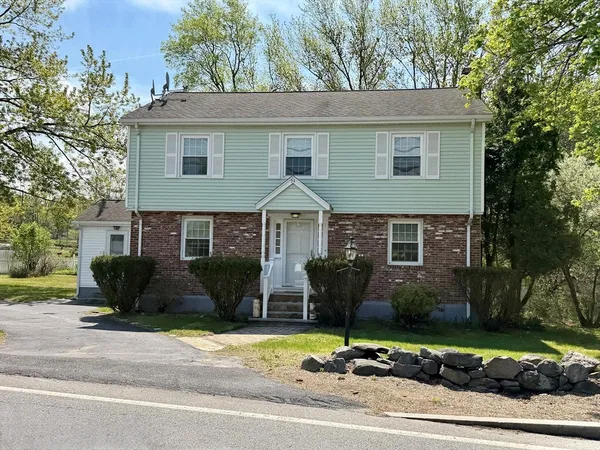 a front view of a house with a garden